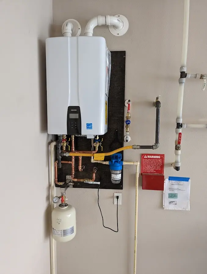 Professional plumber installing copper piping in a Antrim home